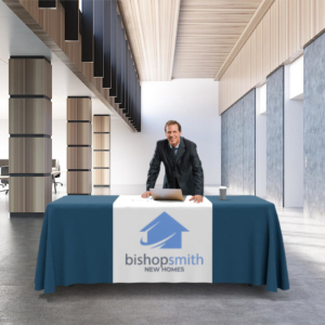 Man standing behind table with table runner